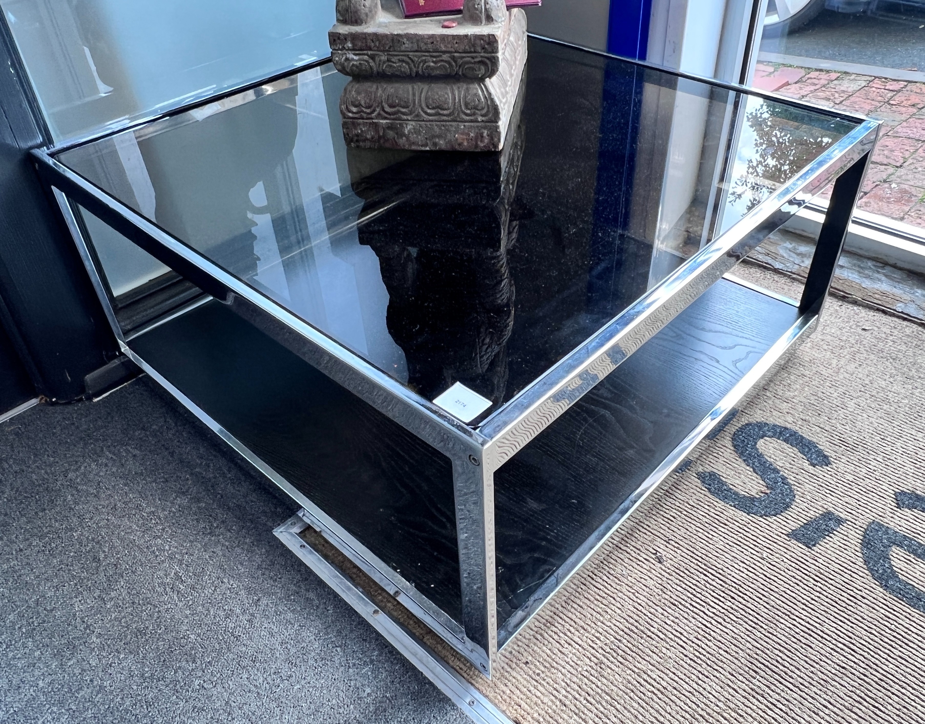 A pair of chrome and smoked glass Merrow associates style two tier occasional tables, width 84cm, depth 83cm, height 42cm